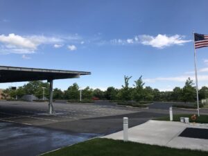 Close-up of freshly sealcoated asphalt with a rich black finish, highlighting clean surface protection and restored curb appeal.