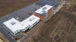 Newly paved industrial asphalt parking and loading areas for warehouses and distribution centers, featuring wide lanes, heavy-duty surfaces, and organized striping for truck and vehicle access.